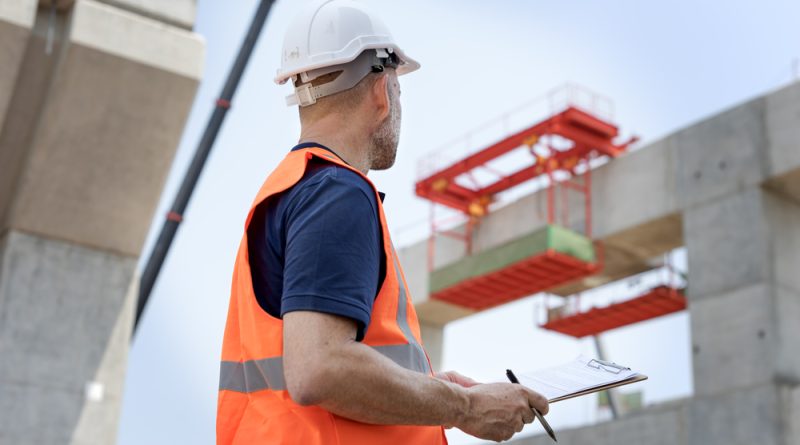 Construction worker looking at a building being built