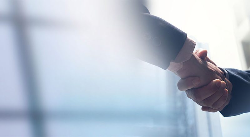 Businessmen shaking hands to support Matt Blowers article