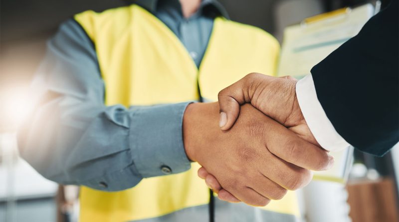 Construction worker and business professional shaking hands to support Colin Briscoe Construction article