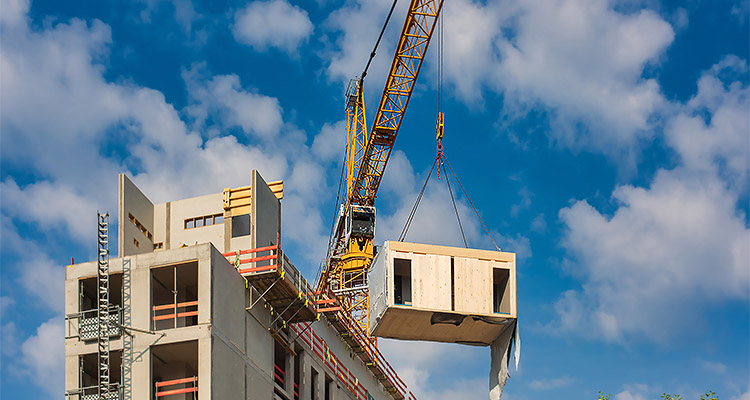 Construction site of an office building in Berlin. The new structure will be built in modular timber construction. MODULAR WOODEN HOUSES made out of renewable resources.