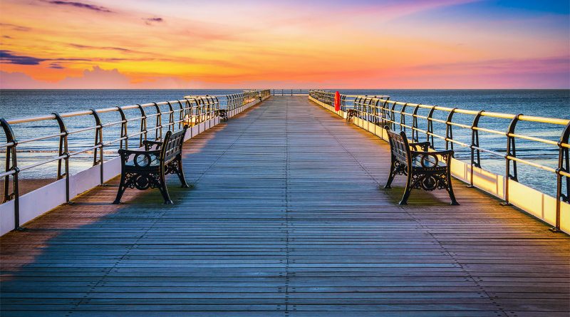 Sunset pier with benches and walkway to support Ryde Pier railway article