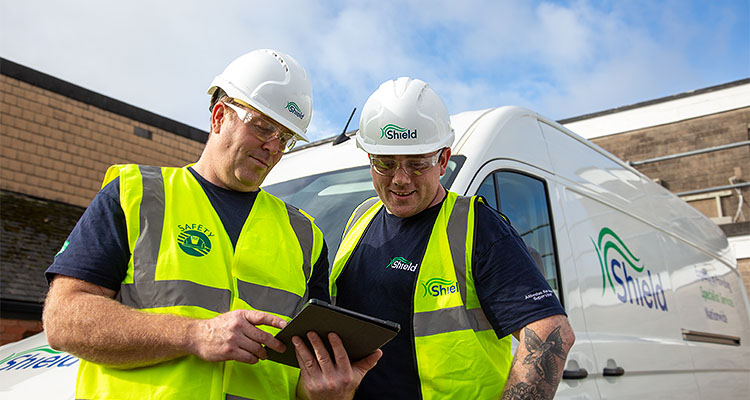 two workers from Shield Environmental Services