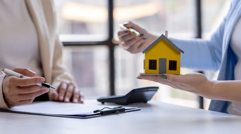 Business professionals talking over papers and house model to support Tax Services for Construction article