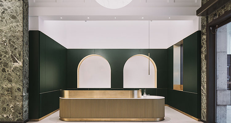 reception area, featuring a modern design with dark green paneled walls