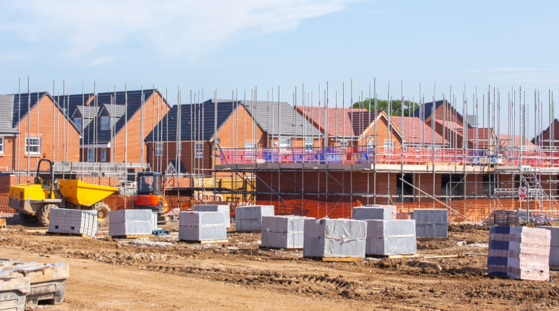 UK construction market showing active residential housing development with scaffolding, equipment, and brickwork in progress