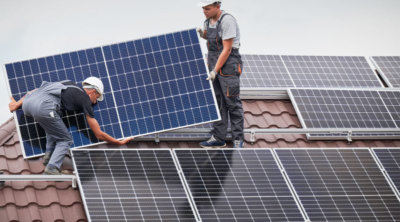 Solar panels being installed on residential rooftops in the North West of England under a low carbon retrofit initiative