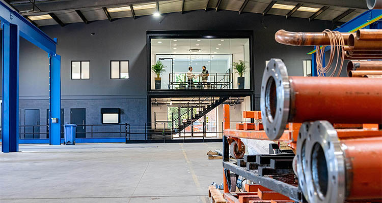 the interior of a large warehouse or factory with an industrial mezzanine floor