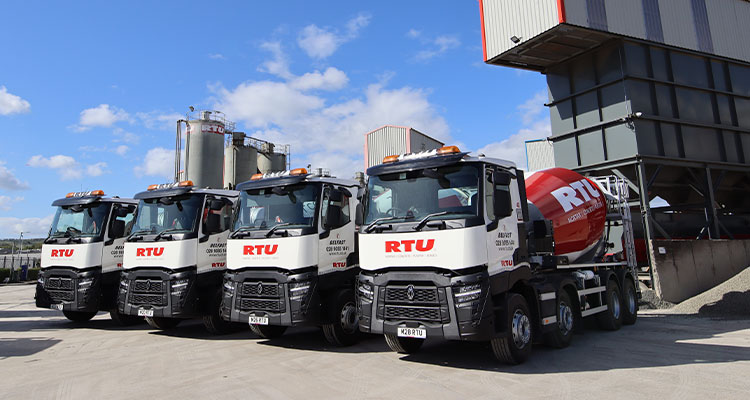a fleet of concrete mixer trucks from a company called RT