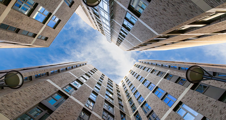 a view looking up into the courtyard of a modern residential development known as The Holloway in North London