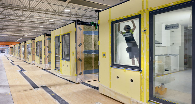 modular homes or building units in various stages of assembly within a factory