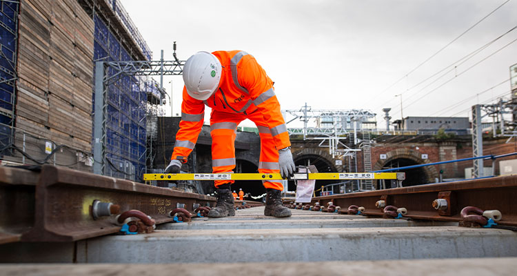 railway worker performing track maintenance.
