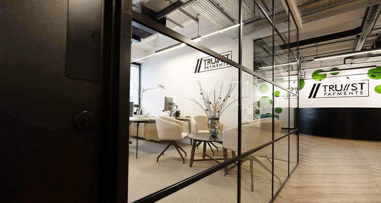 the interior of an office space occupied by a company named Tru//st Payments
