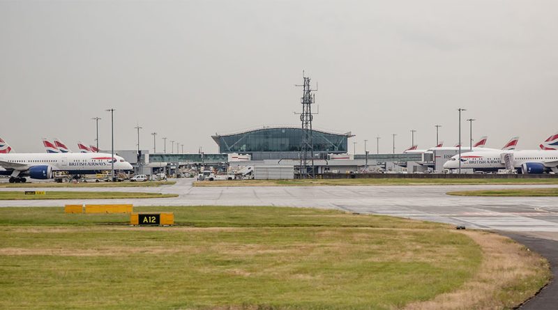 A wide-angle view of Heathrow Airport terminals and runway infrastructure under clear skies, representing expansion plans.