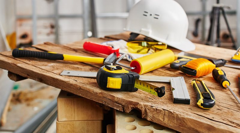 Construction workers using professional power tools on a modern building site